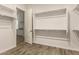 Walk-in closet featuring wood floors and closet shelving at 17304 W Royal Palm Rd, Waddell, AZ 85355