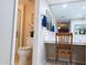 Bright bathroom featuring a mirrored wall, white cabinetry, and a cozy vanity area with a decorative chair and tile flooring at 17404 N 99Th Ave # 126, Sun City, AZ 85373