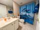Bathroom featuring a dolphin-themed shower curtain, white vanity and toilet at 17404 N 99Th Ave # 126, Sun City, AZ 85373