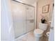 Bathroom featuring a glass shower and toilet with neutral tones at 17404 N 99Th Ave # 126, Sun City, AZ 85373