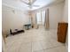 Neutral bedroom shows tile floors, window with shutters and shelving, ceiling fan and gym equipment at 17404 N 99Th Ave # 126, Sun City, AZ 85373