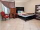 Cozy bedroom featuring tile flooring, a queen-sized bed, and coordinated furnishings at 17404 N 99Th Ave # 126, Sun City, AZ 85373