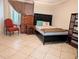 Well-lit bedroom featuring tile flooring, a queen-sized bed, and coordinated furnishings at 17404 N 99Th Ave # 126, Sun City, AZ 85373