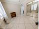 Neutral bedroom features tile floors, a ceiling fan, and mirrored closet doors at 17404 N 99Th Ave # 126, Sun City, AZ 85373