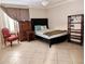 The bedroom features a comfortable bed, dresser, tile flooring and plenty of light at 17404 N 99Th Ave # 126, Sun City, AZ 85373