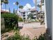 Landscaped courtyard showcases vibrant desert plants, mature trees, and the community buildings at 17404 N 99Th Ave # 126, Sun City, AZ 85373