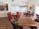 Spacious game room with tables, chairs, and convenient access to a kitchenette and outdoor area at 17404 N 99Th Ave # 126, Sun City, AZ 85373