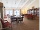 Bright game room and library with vaulted ceilings and ample seating for reading and socializing at 17404 N 99Th Ave # 126, Sun City, AZ 85373