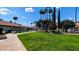 Well-maintained grassy grounds featuring lush trees, mature shrubs, and manicured landscaping at 17404 N 99Th Ave # 126, Sun City, AZ 85373