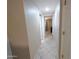 Hallway with tile flooring leads to bedrooms and living areas in this home at 17404 N 99Th Ave # 126, Sun City, AZ 85373
