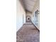 Inviting hallway with arched doorways and patterned carpeting at 17404 N 99Th Ave # 126, Sun City, AZ 85373
