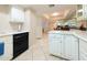 Bright kitchen shows tile floors, and white cabinets and countertops at 17404 N 99Th Ave # 126, Sun City, AZ 85373