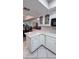 Bright kitchen with white cabinetry and a view of the dining area at 17404 N 99Th Ave # 126, Sun City, AZ 85373