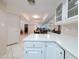 Bright eat-in kitchen features white cabinetry and a mirror backsplash reflecting the dining area at 17404 N 99Th Ave # 126, Sun City, AZ 85373