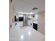 Bright kitchen with stainless steel appliances, white cabinetry, and natural light from a skylight at 17404 N 99Th Ave # 126, Sun City, AZ 85373