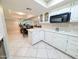 Bright kitchen featuring white cabinetry, modern appliances, and tile flooring at 17404 N 99Th Ave # 126, Sun City, AZ 85373