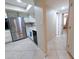 Kitchen boasts stainless steel refrigerator, white cabinetry and a skylight, providing ample lighting at 17404 N 99Th Ave # 126, Sun City, AZ 85373