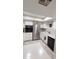 Bright kitchen featuring a stainless steel refrigerator and white cabinetry at 17404 N 99Th Ave # 126, Sun City, AZ 85373