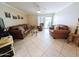 Bright living room with comfortable seating, tile flooring, and patio access at 17404 N 99Th Ave # 126, Sun City, AZ 85373