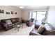 Inviting living room with cozy seating and sliding door access to outdoor patio at 17404 N 99Th Ave # 126, Sun City, AZ 85373