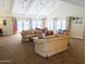 Comfortable living room featuring sofas and seating, with natural light from nearby windows at 17404 N 99Th Ave # 126, Sun City, AZ 85373