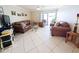 Cozy living room with leather furniture and a sliding glass door to the outdoor patio at 17404 N 99Th Ave # 126, Sun City, AZ 85373