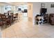Open living area with tile floors, adjacent to a kitchen with white cabinets and stainless steel appliances at 17404 N 99Th Ave # 126, Sun City, AZ 85373