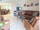 Comfortable living room featuring a leather sofa and decorative accents at 17404 N 99Th Ave # 126, Sun City, AZ 85373