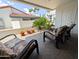 Inviting covered patio with comfortable seating, potted plants, and views of tropical landscaping at 17404 N 99Th Ave # 126, Sun City, AZ 85373