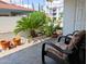 Serene covered patio features cozy seating, vibrant flowers, and lush greenery at 17404 N 99Th Ave # 126, Sun City, AZ 85373