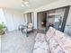 Inviting sunroom with tiled floor features neutral-colored furniture at 17404 N 99Th Ave # 126, Sun City, AZ 85373