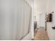 Bathroom with tile flooring, shower and tub with curtain, vanity, mirror, and natural light at 17649 W Buchanan St, Goodyear, AZ 85338