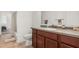 Bathroom boasting single vanity with granite countertop, tile flooring, and tub with shower at 17649 W Buchanan St, Goodyear, AZ 85338