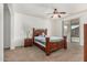 Cozy bedroom with a ceiling fan, plush carpet, and a sliding glass door for natural light at 17649 W Buchanan St, Goodyear, AZ 85338