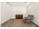 Carpeted bedroom featuring a plush recliner, a dresser, and a well-lit space at 17649 W Buchanan St, Goodyear, AZ 85338