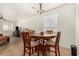 Cozy dining area with a round wooden table, four chairs, and an open layout, perfect for everyday meals and entertaining at 17649 W Buchanan St, Goodyear, AZ 85338
