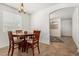 Warm dining area with a round wooden table, four chairs, and ample natural light, ideal for Gathering meals and gatherings at 17649 W Buchanan St, Goodyear, AZ 85338