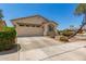 Inviting front exterior showcasing a two-car garage, desert landscaping, and a well-maintained lawn, creating excellent curb appeal at 17649 W Buchanan St, Goodyear, AZ 85338