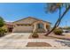 Charming single-story home featuring a two-car garage, desert landscaping, and a beige stucco facade under a sunny blue sky at 17649 W Buchanan St, Goodyear, AZ 85338