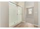 Contemporary bathroom features a glass-enclosed shower and view into carpeted bedroom at 18354 W Patrick Ln, Surprise, AZ 85387