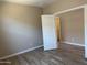 Neutral bedroom features wood floors, a closet, and a bright, airy space at 18354 W Patrick Ln, Surprise, AZ 85387