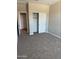 Cozy bedroom featuring a closet with sliding doors and soft, neutral carpeting at 18354 W Patrick Ln, Surprise, AZ 85387