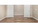 Empty bedroom with wood-look tile flooring and neutral paint at 18354 W Patrick Ln, Surprise, AZ 85387