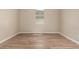 Neutral bedroom with wood-look tile flooring and natural light at 18354 W Patrick Ln, Surprise, AZ 85387