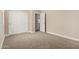 Bedroom with plush carpet, closet doors, and a doorway to the bathroom at 18354 W Patrick Ln, Surprise, AZ 85387