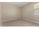 Neutral bedroom features plush carpet, a window, and ample natural light at 18354 W Patrick Ln, Surprise, AZ 85387