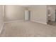 Large bedroom with carpet, neutral walls, and attached bathroom at 18354 W Patrick Ln, Surprise, AZ 85387