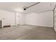 A spacious two car garage, featuring clean floors, and a new door leading into the home at 18354 W Patrick Ln, Surprise, AZ 85387