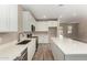 Bright kitchen features white cabinets, stainless steel appliances, and ample counter space at 18354 W Patrick Ln, Surprise, AZ 85387