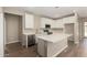Bright kitchen features white cabinets, stainless steel appliances, and a large center island, perfect for entertaining at 18354 W Patrick Ln, Surprise, AZ 85387